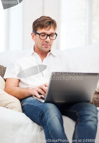 Image of man working with laptop at home