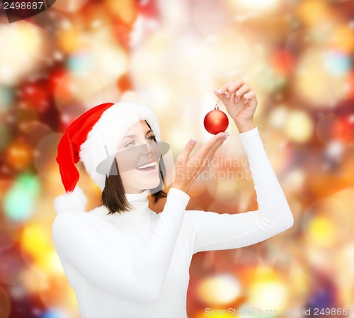 Image of woman in santa helper hat with christmas ball