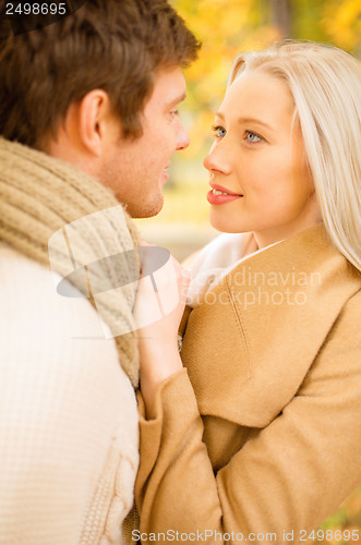 Image of romantic couple kissing in the autumn park