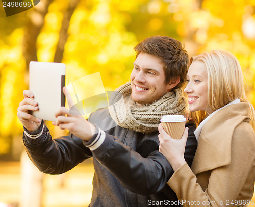 Image of couple taking photo picture autumn park