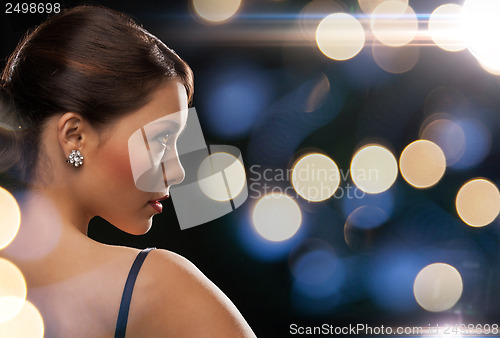 Image of woman in evening dress wearing diamond earrings