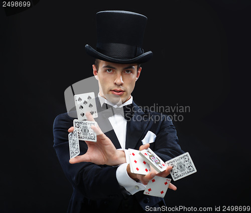 Image of magician showing trick with playing cards