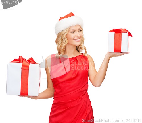 Image of woman in santa helper hat with many gift boxes