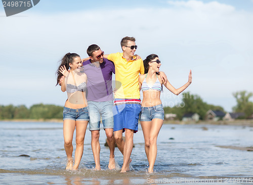 Image of group of friends having fun on the beach