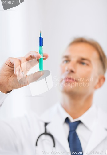 Image of male doctor holding syringe with injection