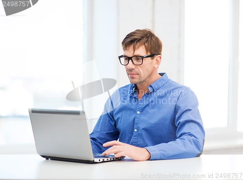 Image of man working with laptop at home