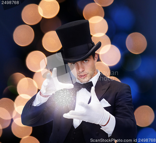 Image of magician in top hat showing trick