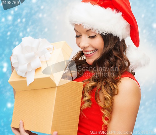 Image of smiling woman in santa helper hat with gift box