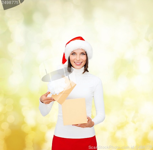 Image of smiling woman in santa helper hat with gift box