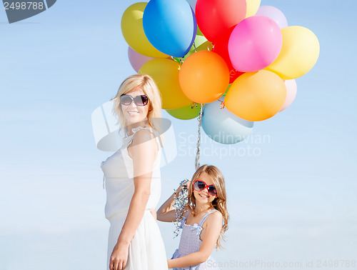 Image of mother and child with colorful balloons