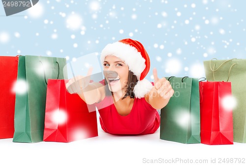 Image of woman in red shirt with shopping bags