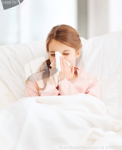 Image of ill girl with paper tissue