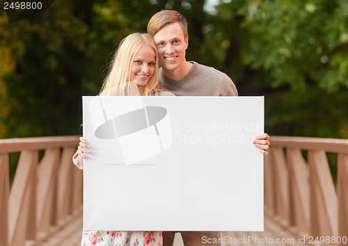 Image of romantic couple with blank white board