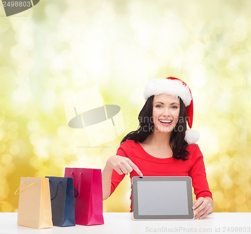 Image of woman in santa helper hat with tablet pc