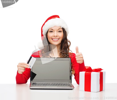 Image of woman with gift, laptop computer and credit card
