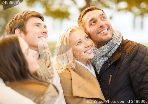 Image of group of friends having fun in autumn park