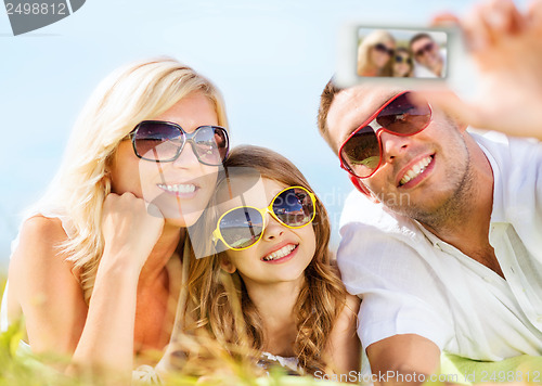Image of happy family with camera taking picture