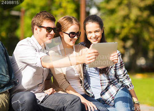 Image of teenagers taking photo outside