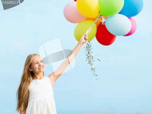 Image of happy girl with colorful balloons