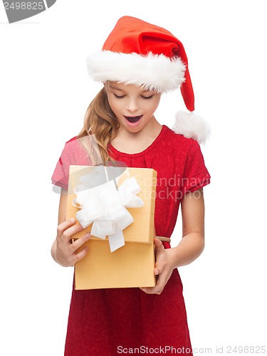 Image of smiling girl in santa helper hat with gift box