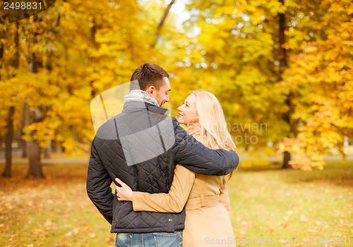 Image of romantic couple kissing in the autumn park