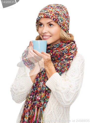 Image of woman in hat with red tea or coffee mug