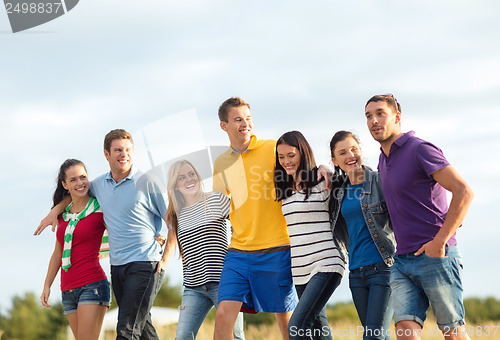 Image of group of friends having fun on the beach