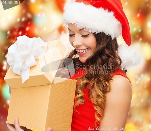 Image of smiling woman in santa helper hat with gift box