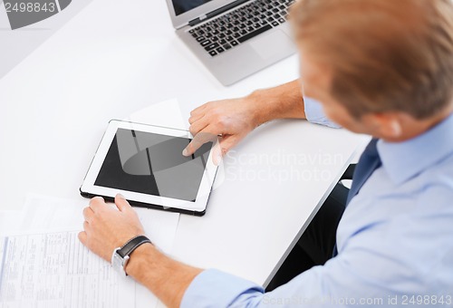 Image of businessman with tablet pc in office