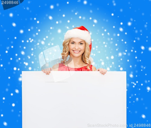 Image of woman in santa helper hat with blank white board