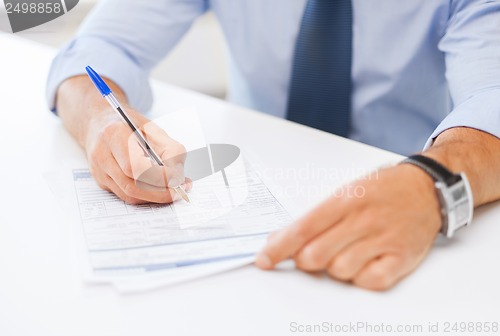 Image of man signing a contract