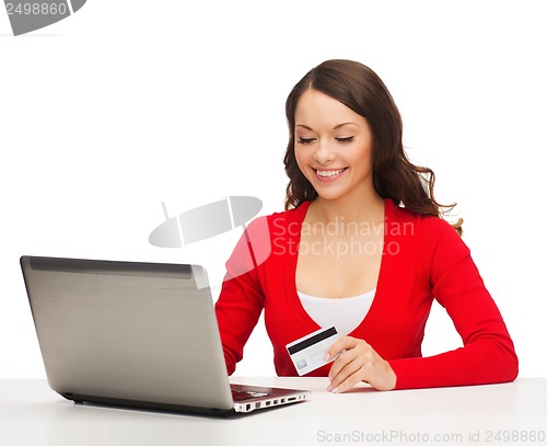 Image of happy woman with laptop computer and credit card