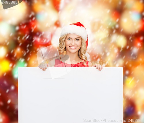 Image of woman in santa helper hat with blank white board