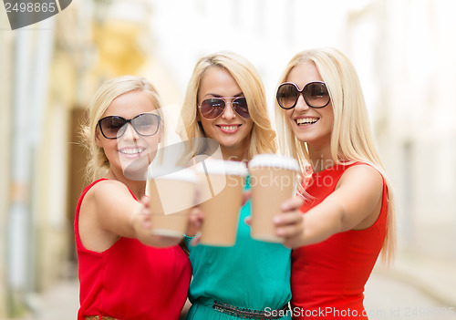 Image of women with takeaway coffee cups in the city