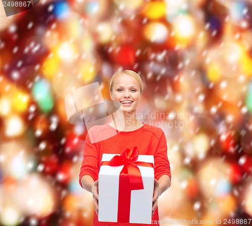 Image of smiling woman in red sweater with gift box