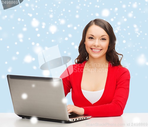 Image of smiling woman in red clothes with laptop computer