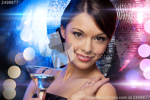 Image of woman with cocktail and disco ball
