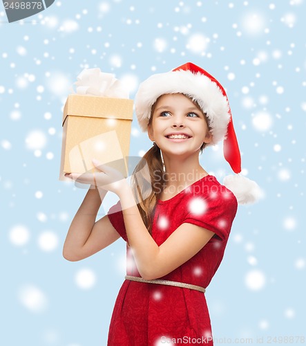 Image of smiling girl in santa helper hat with gift box