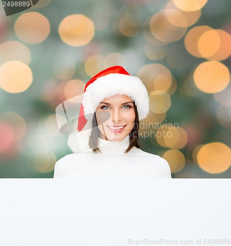 Image of woman in santa helper hat with blank white board