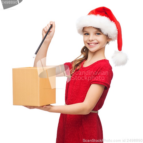 Image of smiling girl in santa helper hat with gift box