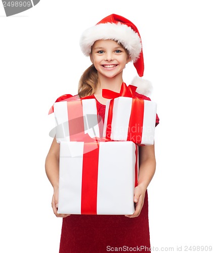 Image of girl in santa helper hat with many gift boxes