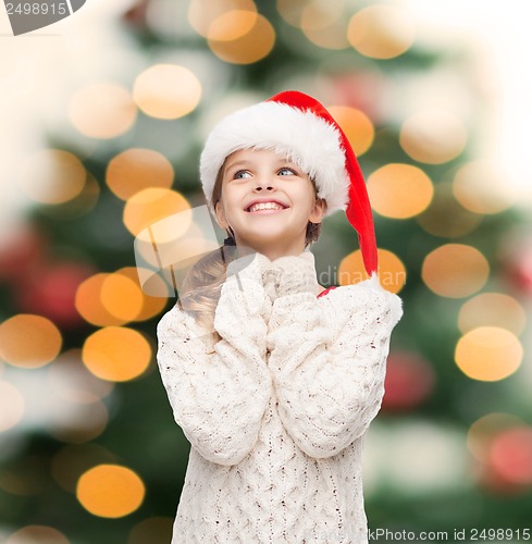 Image of dreaming girl in santa helper hat
