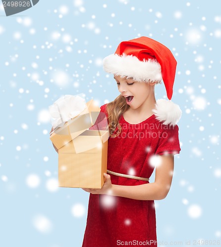 Image of smiling girl in santa helper hat with gift box