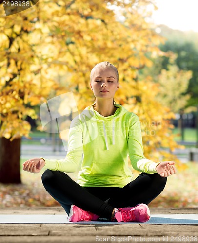 Image of woman doing yoga outdoors