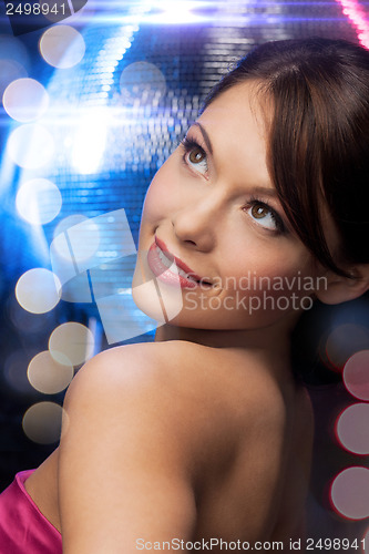 Image of woman in evening dress wearing diamond earrings