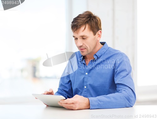 Image of man working with tablet pc at home