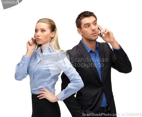 Image of woman and man with cell phones calling