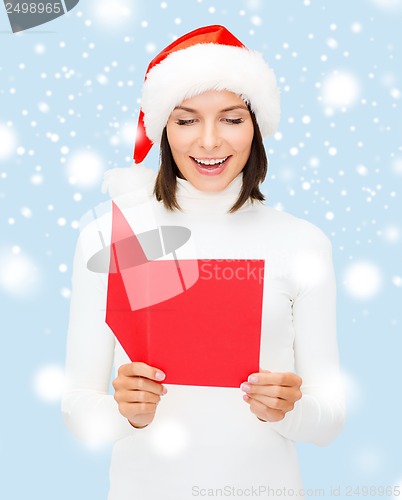 Image of woman in santa helper hat with blank red postcard