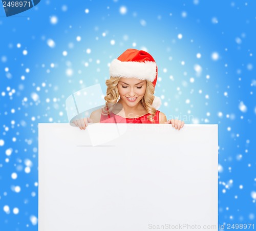 Image of woman in santa helper hat with blank white board