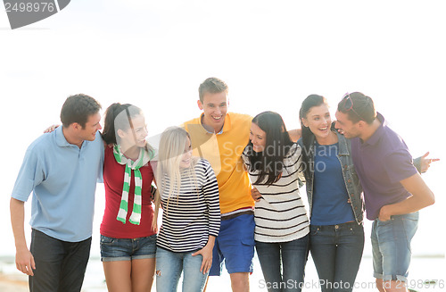 Image of group of friends having fun on the beach